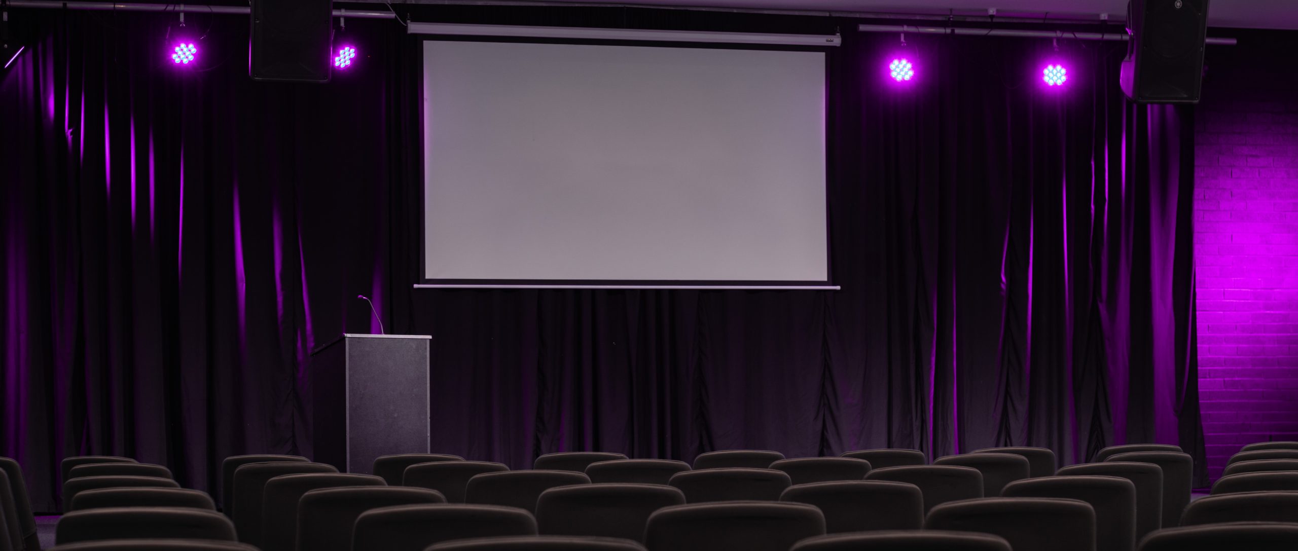 A purple-lit stage set up in preparation for a wellness retreat in Sydney. Wellness retreat accommodation, Sydney