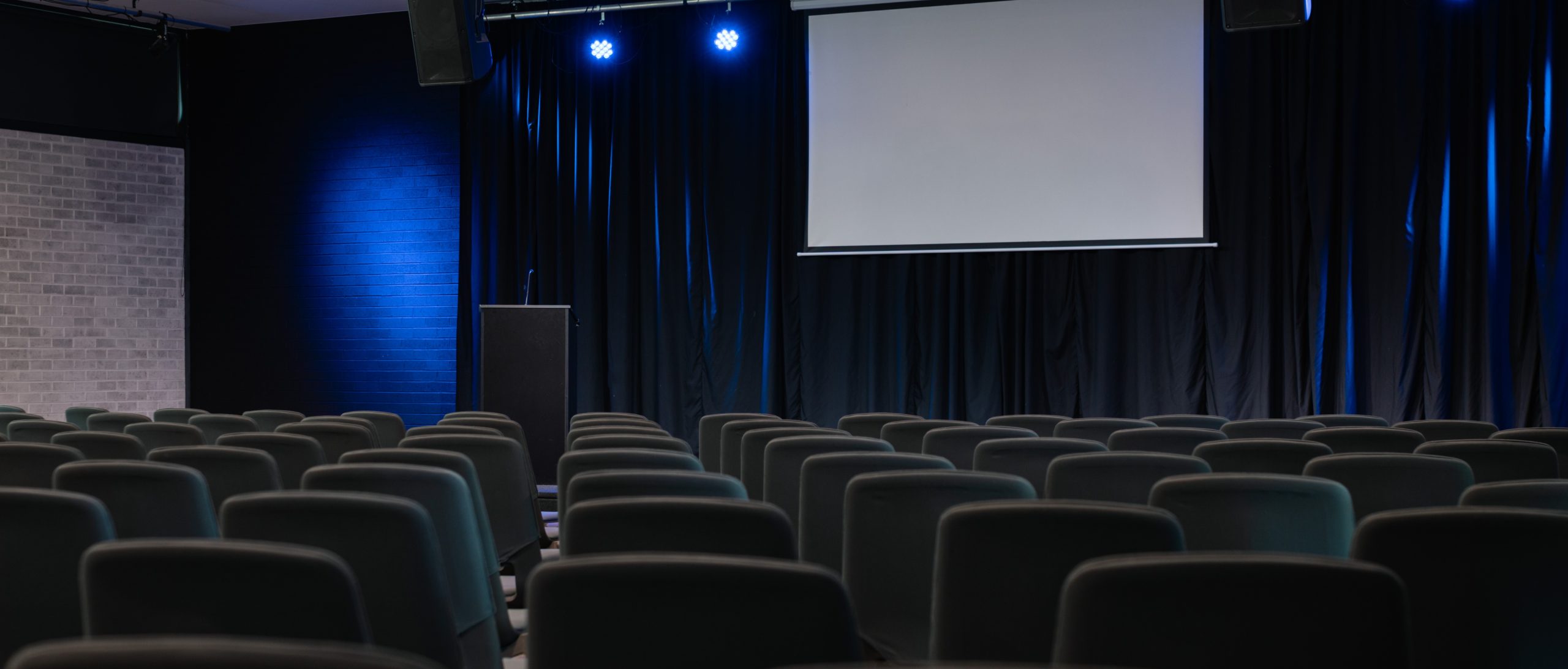 A school camp venue with an auditorium in Sydney, equipped with two projectors, customised lighting and a sound system.