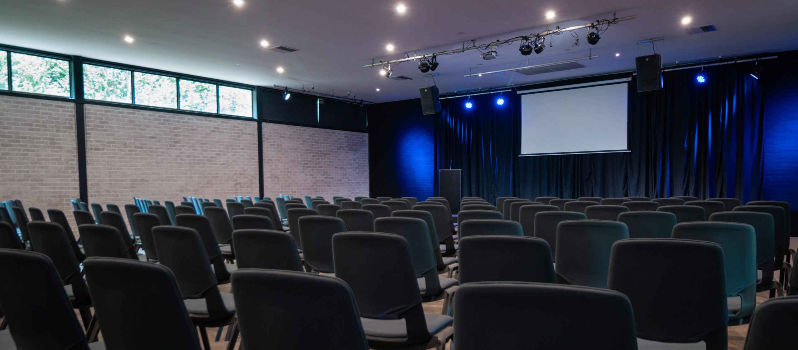 A large auditorium at a professional meeting venue in Sydney.